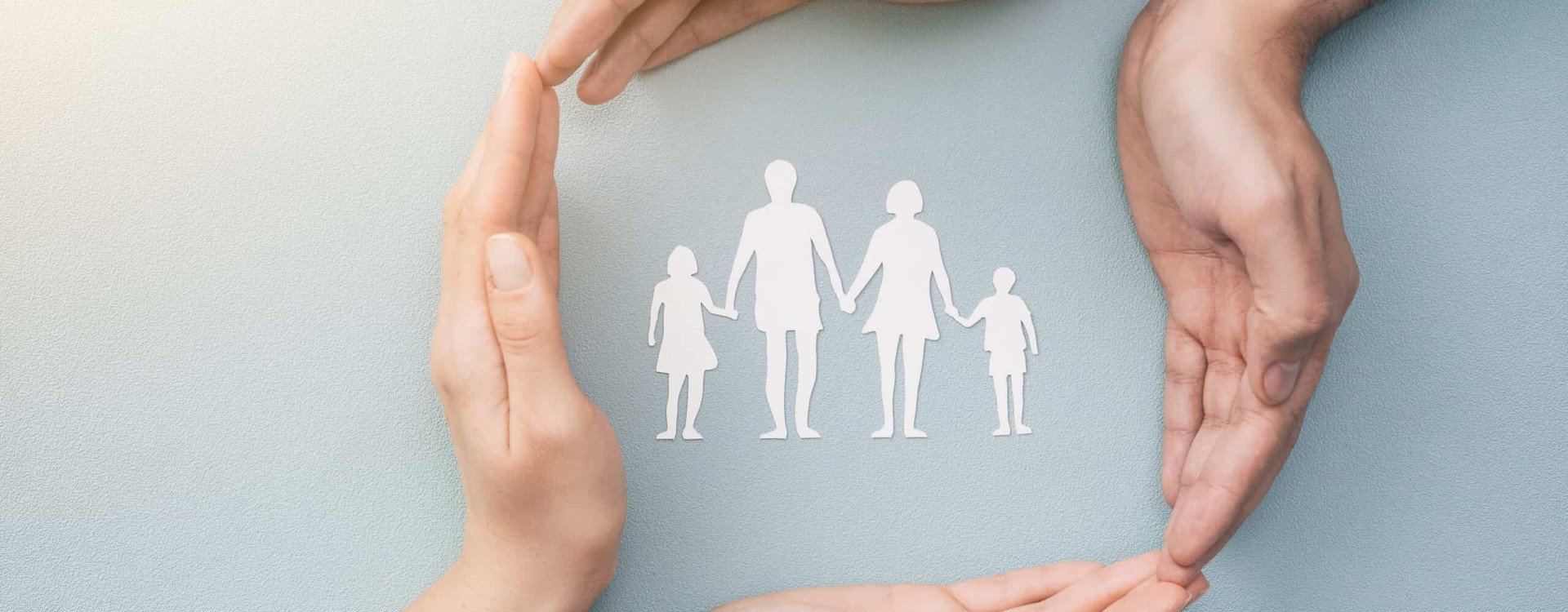 Hands,With,Cut,Out,Paper,Silhouette,On,Table.,Family,Care